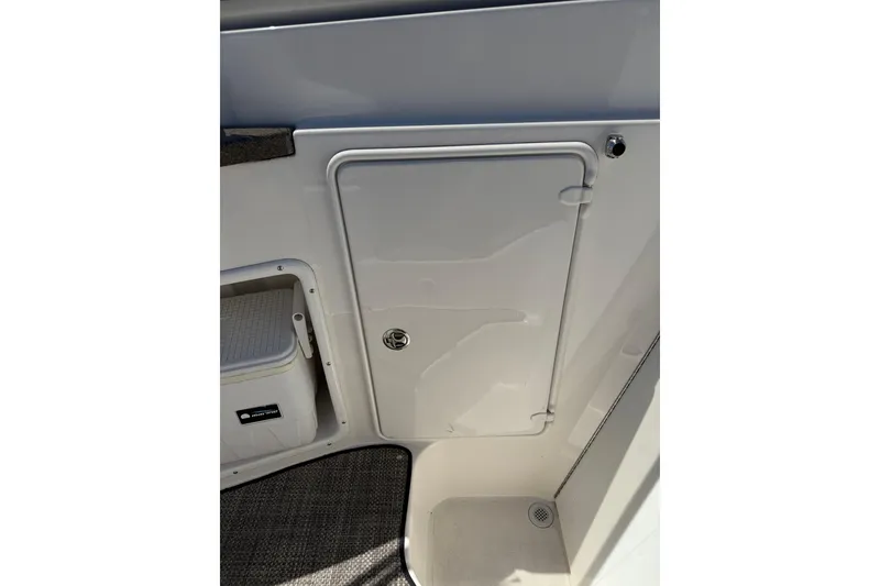 Slide: The Image of 2005 Regal Commodore 2665 boat interior with storage compartment and carpeted floor. - 37