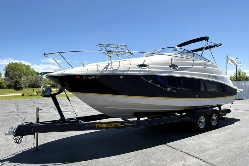 Slide: The Image of 2005 Regal Commodore 2665 boat on trailer under clear blue sky. - 4