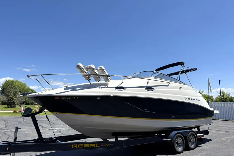 Slide: The Image of 2005 Regal Commodore 2665 boat on trailer under clear blue sky. - 8
