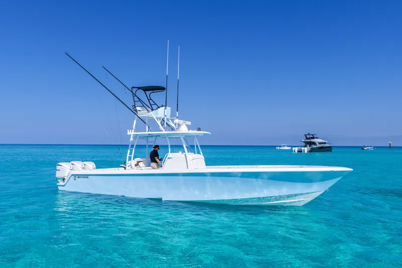Slide: The Image of 2026 Contender 39 ST boat on clear blue water under a sunny sky. - 1