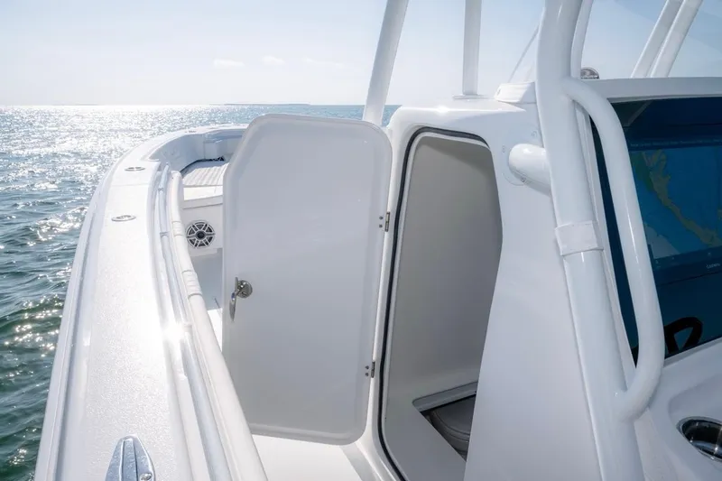 Slide: The Image of 2026 Contender 39 ST boat with open cabin door, ocean view. - 11