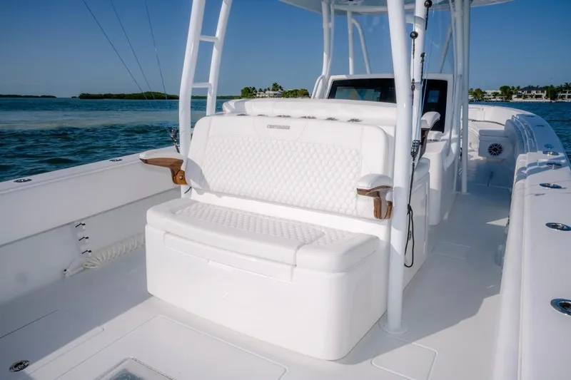 Slide: The Image of 2026 Contender 39 ST boat interior with white seating, ocean backdrop. - 14