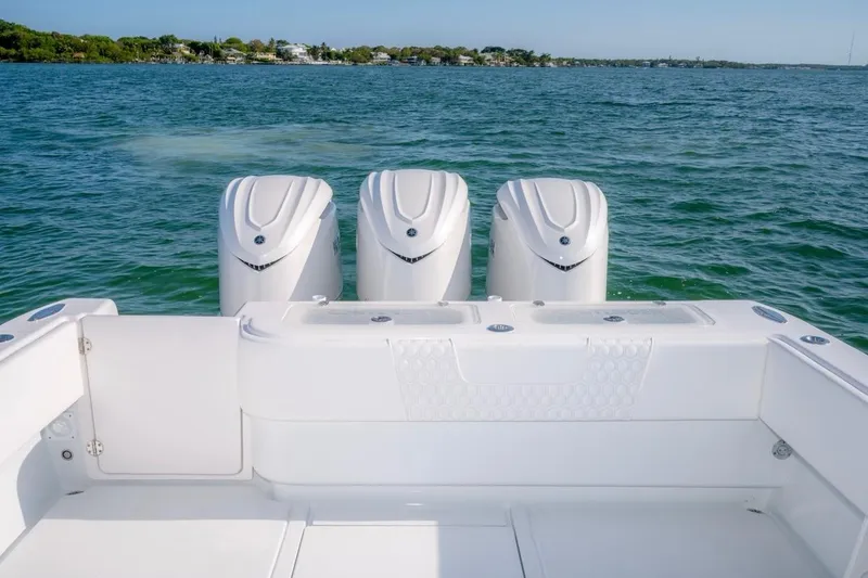 Slide: The Image of 2026 Contender 39 ST boat with triple outboard engines on open water. - 15