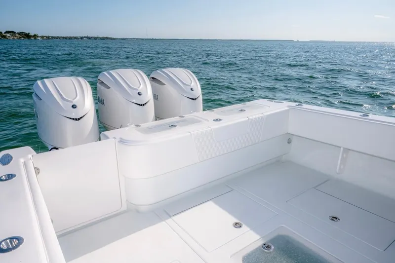 Slide: The Image of 2026 Contender 39 ST boat with triple outboard engines on open water. - 16