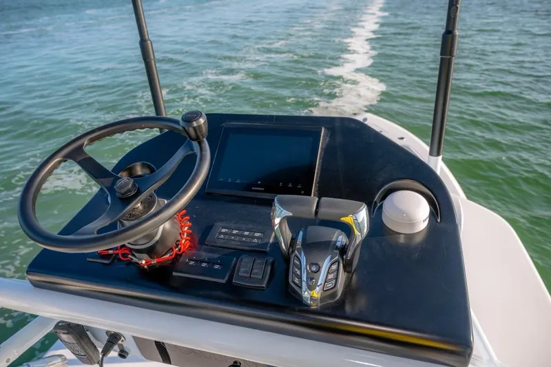 Slide: The Image of 2026 Contender 39 ST boat helm with steering wheel and navigation controls. - 18