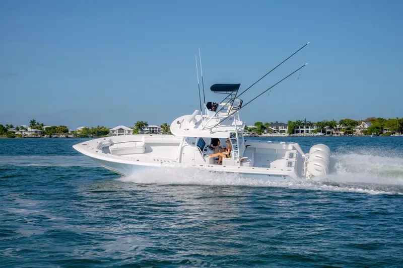 Slide: The Image of 2026 Contender 39 ST boat cruising on a sunny day with fishing rods. - 24