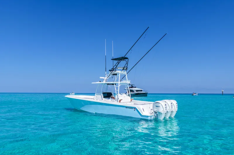 Slide: The Image of 2026 Contender 39 ST boat on clear turquoise water under a bright blue sky. - 3