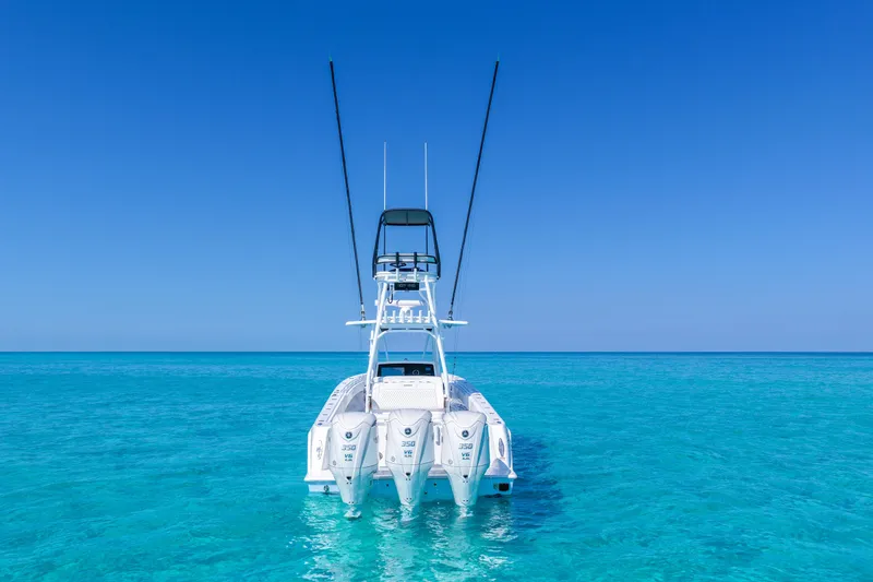 Slide: The Image of 2026 Contender 39 ST boat with triple engines on clear blue water. - 4