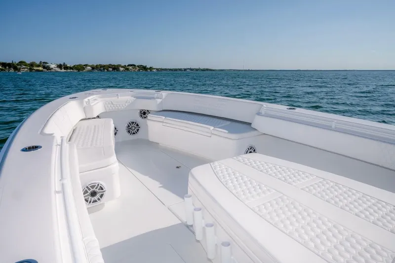 Slide: The Image of 2026 Contender 39 ST boat interior with white seating, on calm blue water. - 6