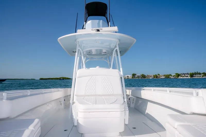 Slide: The Image of 2026 Contender 39 ST boat on calm water, featuring sleek white design and spacious deck. - 7
