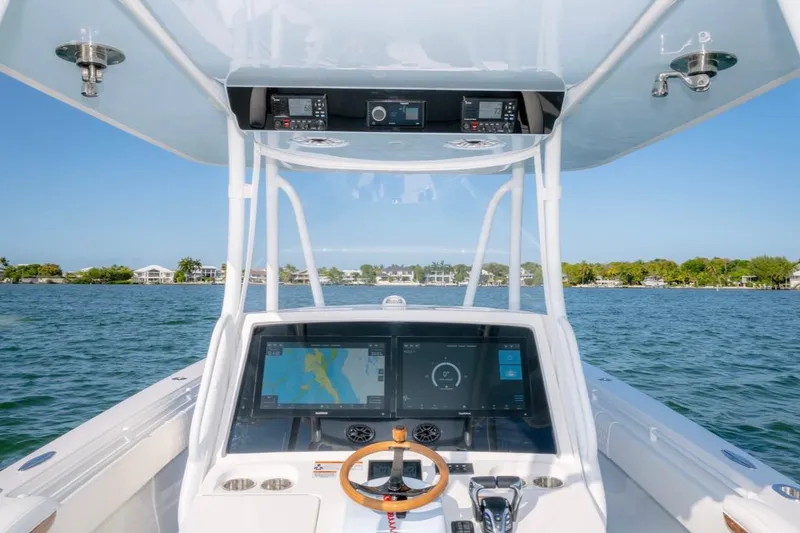 Slide: The Image of 2026 Contender 39 ST boat dashboard with navigation display on open water. - 9