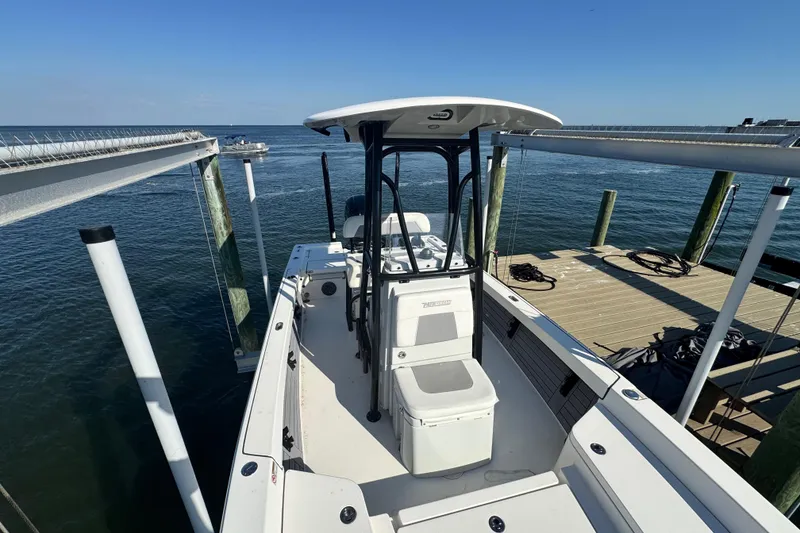 Slide: The Image of 2022 Pathfinder 2400 TRS boat docked by the water on a sunny day. - 10