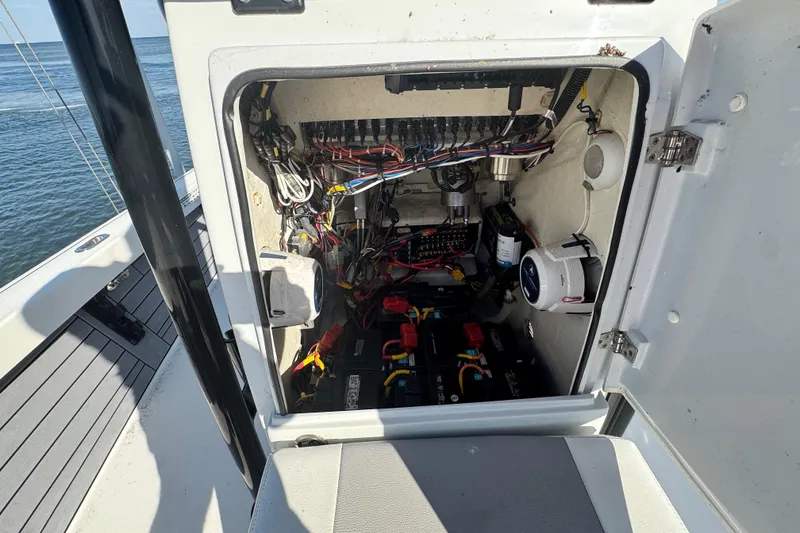 Slide: The Image of Electrical compartment of a 2022 Pathfinder 2400 TRS boat, showing wiring and components. - 13