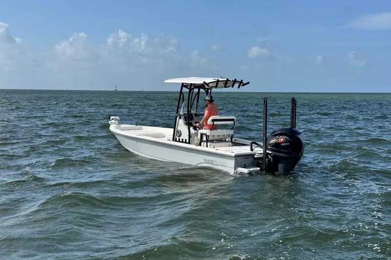 Slide: The Image of 2022 Pathfinder 2400 TRS boat cruising on open water under clear skies. - 14