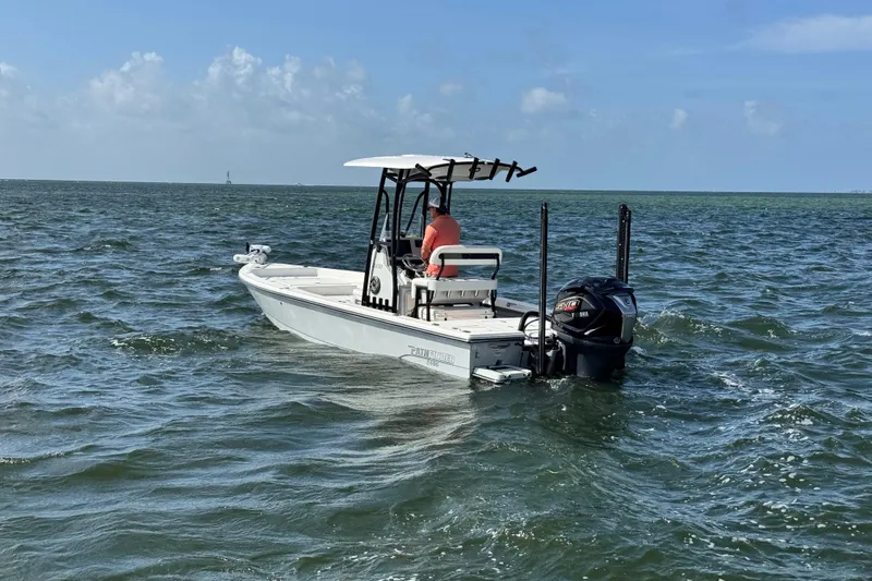 Slide: The Image of 2022 Pathfinder 2400 TRS boat on open water under clear sky. - 15