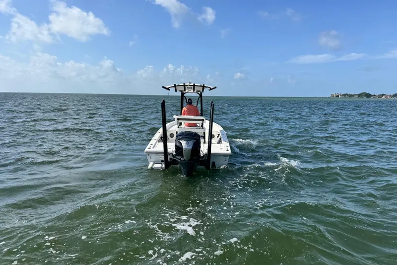 Slide: The Image of 2022 Pathfinder 2400 TRS boat navigating open waters under a clear blue sky. - 17