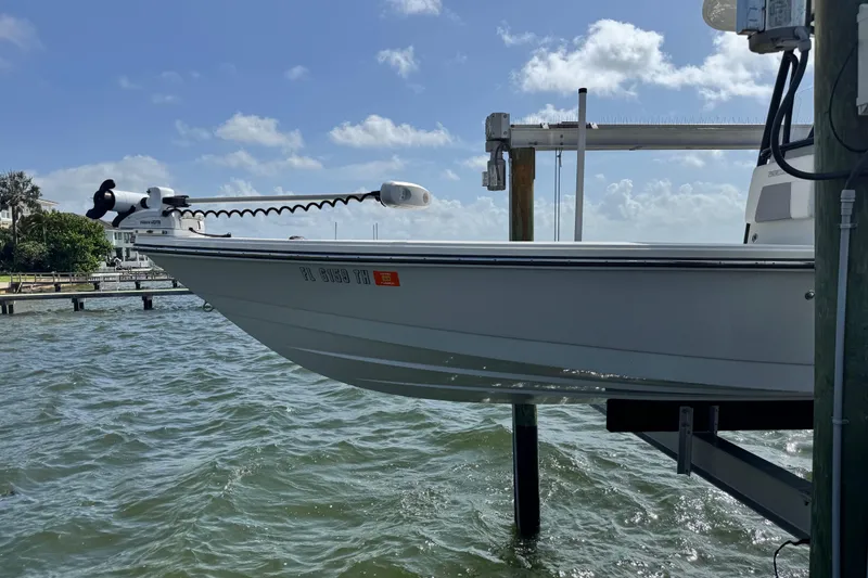 Slide: The Image of 2022 Pathfinder 2400 TRS boat on a lift by the water. - 20