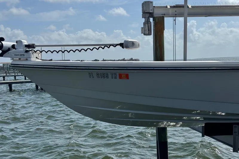Slide: The Image of 2022 Pathfinder 2400 TRS boat docked on water with clear sky background. - 21