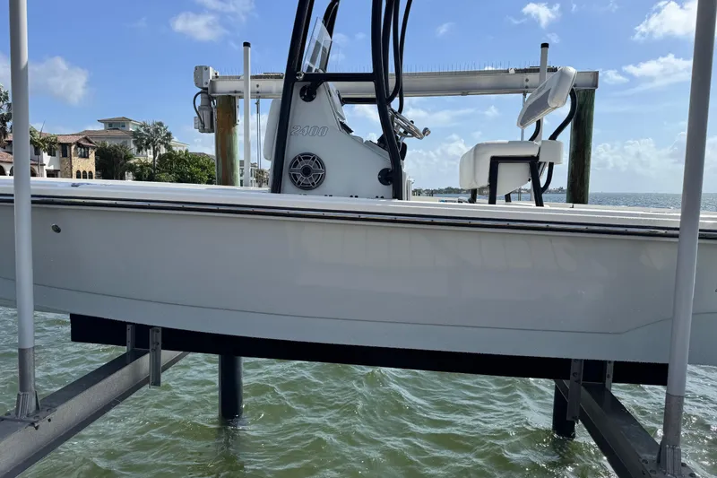Slide: The Image of 2022 Pathfinder 2400 TRS boat on a lift by the water. - 23