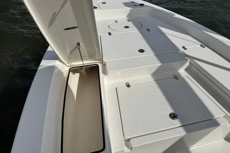 Slide: The Image of Pathfinder 2400 TRS 2022 boat with open storage compartment. - 27