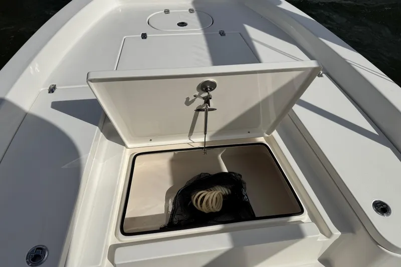 Slide: The Image of Pathfinder 2400 TRS 2022 boat with open storage compartment lid. - 28