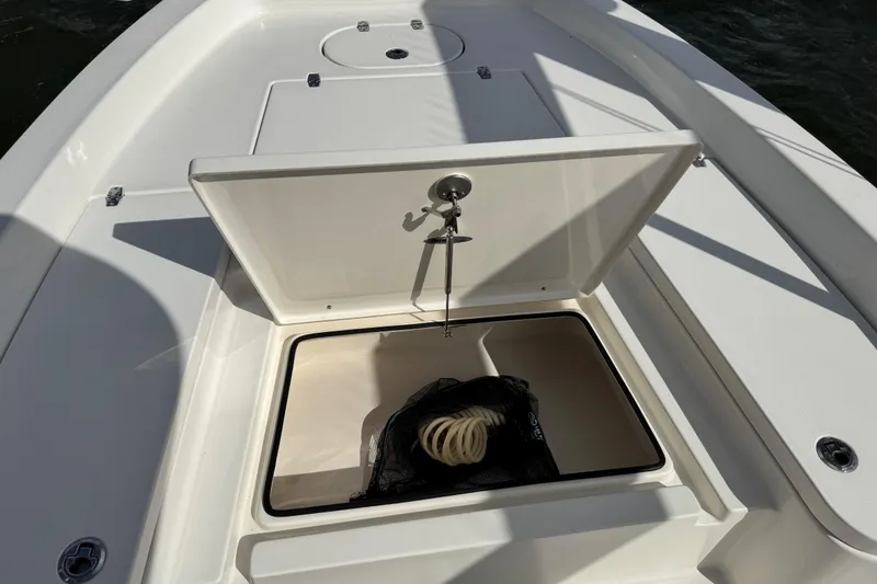 Slide: The Image of 2022 Pathfinder 2400 TRS boat with open storage compartment lid. - 29