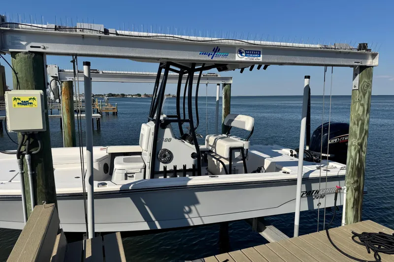 Slide: The Image of 2022 Pathfinder 2400 TRS boat docked on a lift by the water. - 3