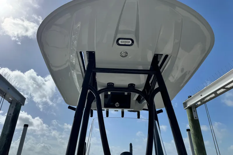 Slide: The Image of 2022 Pathfinder 2400 TRS boat T-top against a bright blue sky. - 37