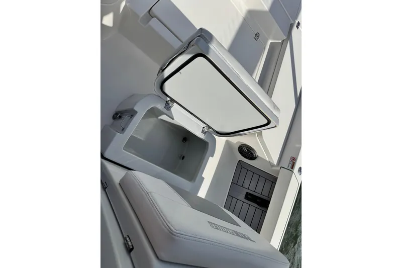 Slide: The Image of 2022 Pathfinder 2400 TRS boat interior with open storage compartment and cushioned seating. - 38