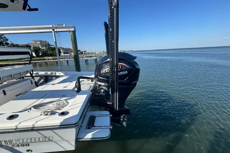 Slide: The Image of 2022 Pathfinder 2400 TRS boat with Yamaha engine docked by the water. - 4