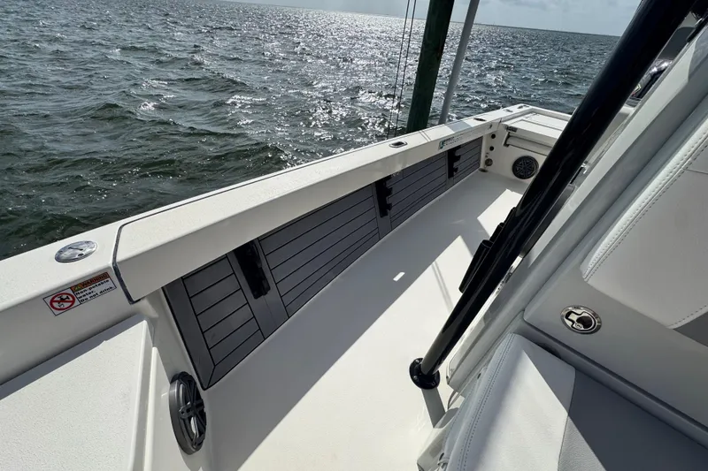 Slide: The Image of 2022 Pathfinder 2400 TRS boat interior with ocean view, showcasing sleek design and storage compartments. - 41