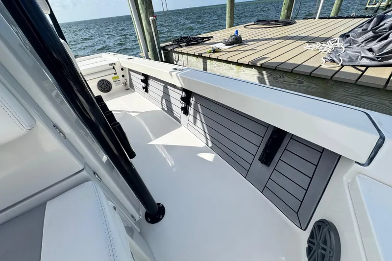 Slide: The Image of 2022 Pathfinder 2400 TRS boat interior, docked by the water, showcasing sleek design. - 42