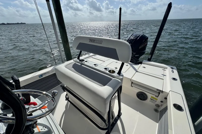 Slide: The Image of Pathfinder 2400 TRS boat, 2022 model, on water with clear sky and sunlight. - 43