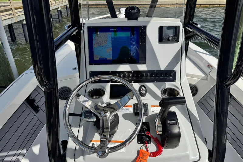 Slide: The Image of 2022 Pathfinder 2400 TRS boat console with steering wheel, navigation screen, and controls. - 44