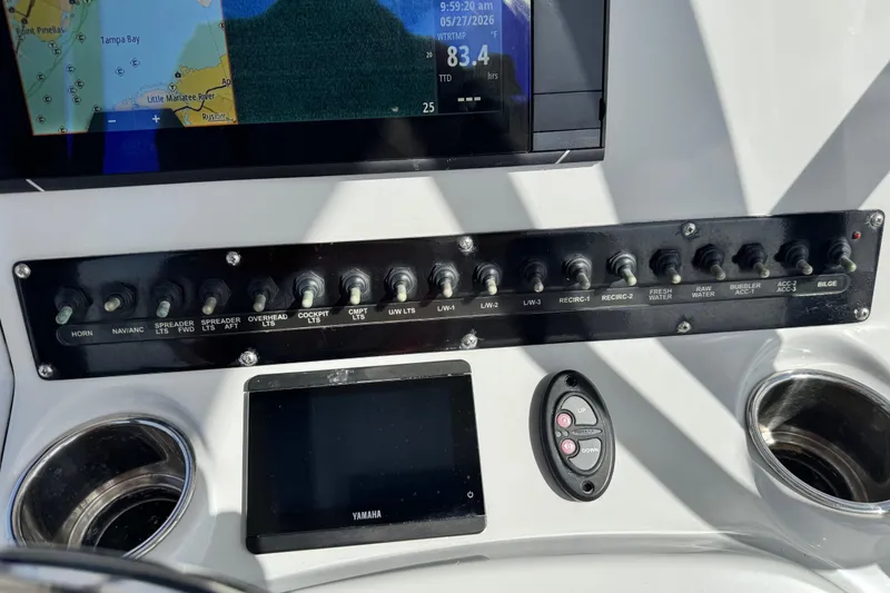 Slide: The Image of Control panel of a 2022 Pathfinder 2400 TRS boat with switches and navigation display. - 45