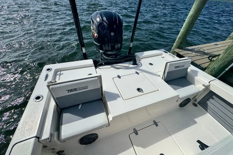 Slide: The Image of 2022 Pathfinder 2400 TRS boat at dock, featuring spacious seating and powerful outboard motor. - 46