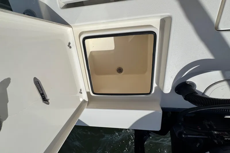 Slide: The Image of Pathfinder 2400 TRS 2022 boat hatch with open storage compartment. - 48