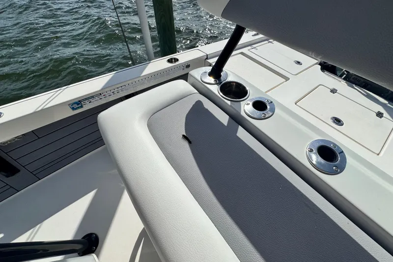 Slide: The Image of 2022 Pathfinder 2400 TRS boat interior with rod holders and seating, on water. - 53