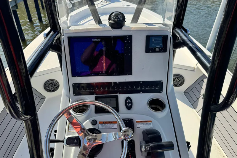 Slide: The Image of 2022 Pathfinder 2400 TRS boat console with steering wheel and navigation display. - 6
