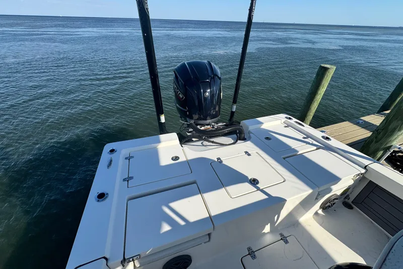 Slide: The Image of 2022 Pathfinder 2400 TRS boat docked, showcasing rear deck and outboard motor. - 8
