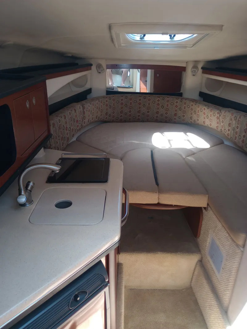 Slide: The Image of Interior of 2005 Sea Ray 270 Amberjack with kitchenette and sleeping area. - 25