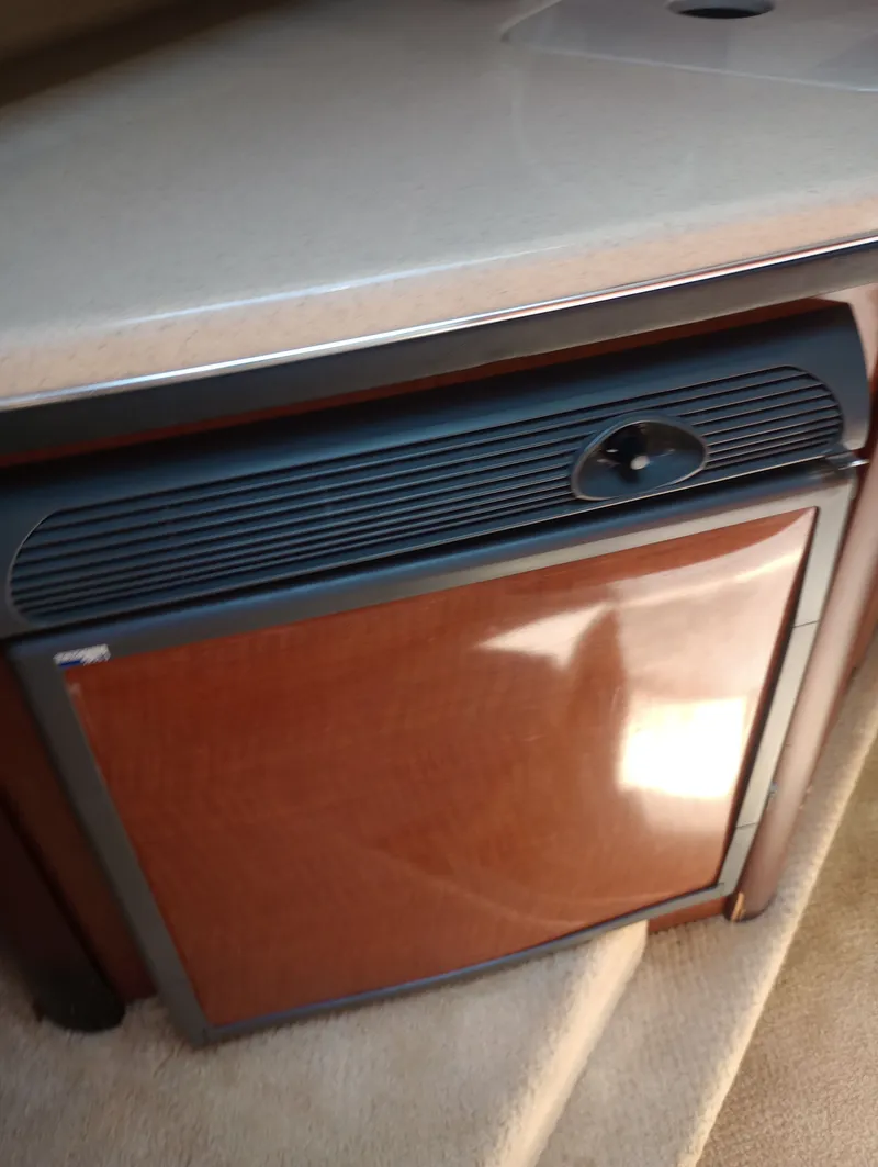 Slide: The Image of Sea Ray 270 Amberjack 2005 kitchen area with refrigerator. - 26