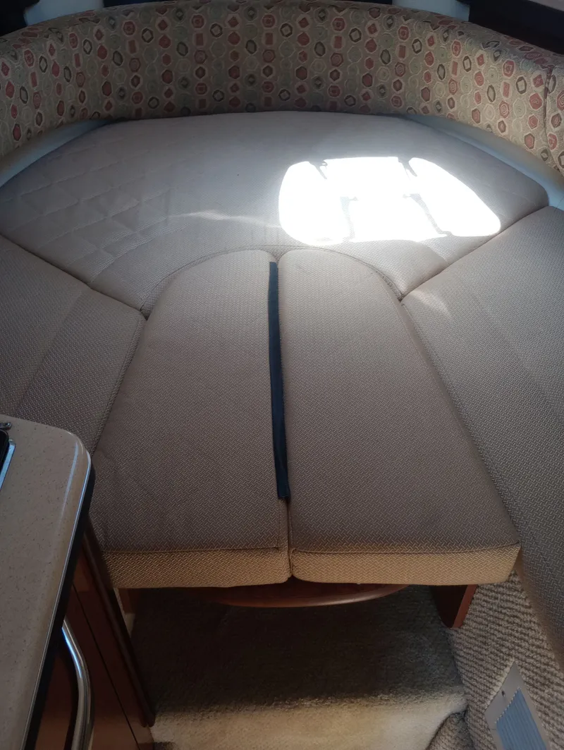 Slide: The Image of Interior of 2005 Sea Ray 270 Amberjack with cushioned seating area. - 27