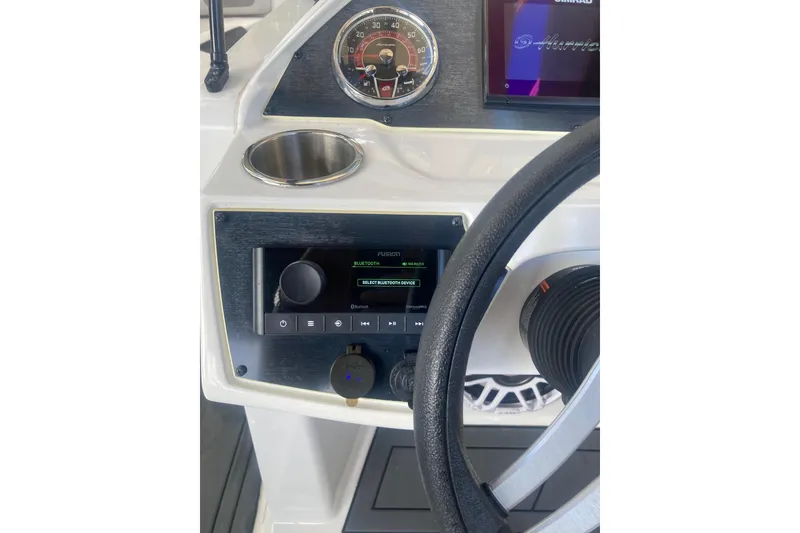 Slide: The Image of 2023 Hurricane SunDeck 235 OB dashboard with steering wheel and control panel. - 17