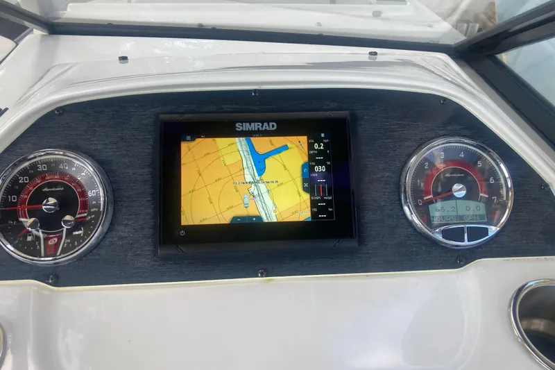 Slide: The Image of Dashboard of 2023 Hurricane SunDeck 235 OB with Simrad navigation display. - 18
