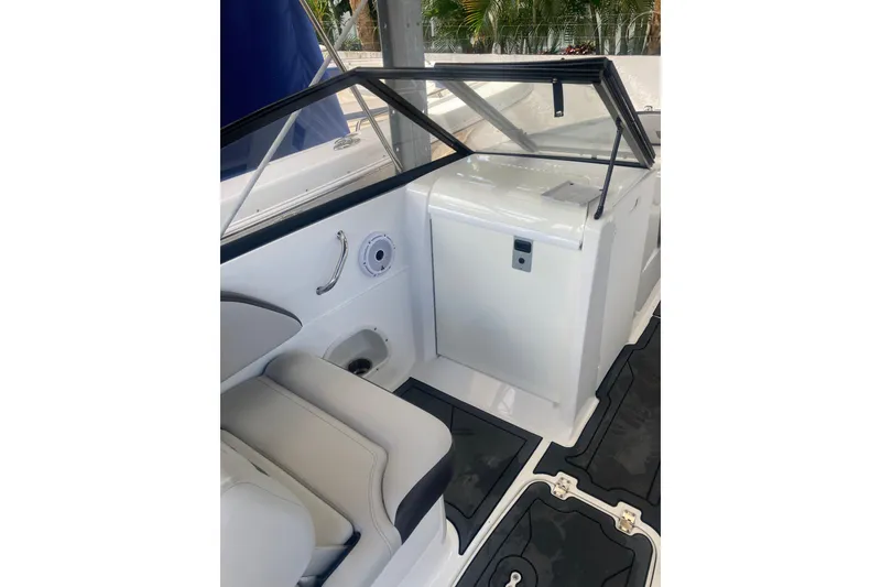 Slide: The Image of 2023 Hurricane SunDeck 235 OB boat interior with seating and storage compartment. - 21