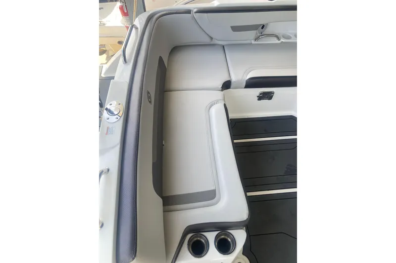 Slide: The Image of Interior seating of 2023 Hurricane SunDeck 235 OB boat, featuring sleek design and cup holders. - 23