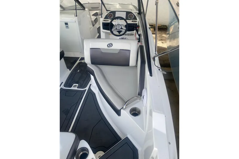 Slide: The Image of 2023 Hurricane SunDeck 235 OB interior with sleek seating and modern dashboard design. - 25