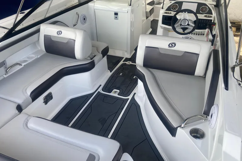 Slide: The Image of 2023 Hurricane SunDeck 235 OB boat interior with sleek seating and modern dashboard design. - 26