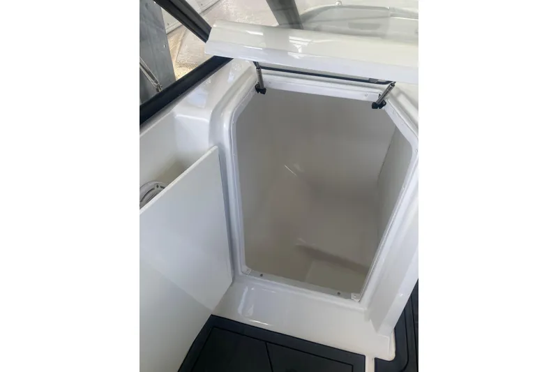 Slide: The Image of 2023 Hurricane SunDeck 235 OB boat storage compartment, open and empty. - 27